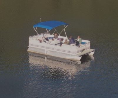 A pontoon boat with a blue canopy and several passengers on calm water.