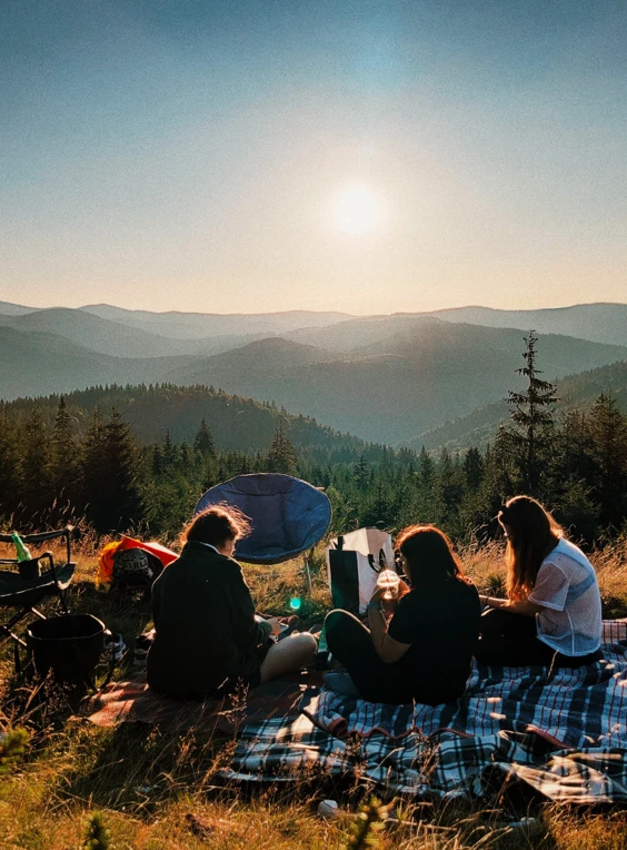 friends grilling on a picnic blanket