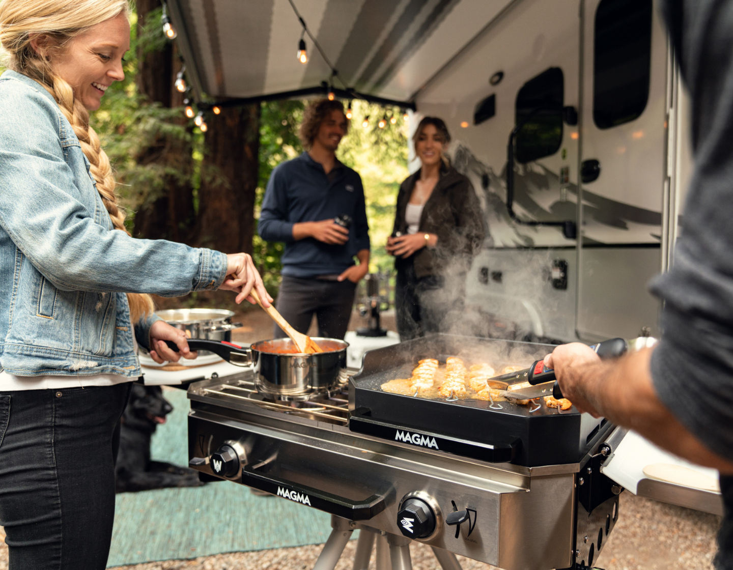 RV cooking scene with friends enjoying the magma crossover double burner stove and griddle